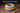 A spaniel bowl in rainbow colours with the name Bailey on the rim.